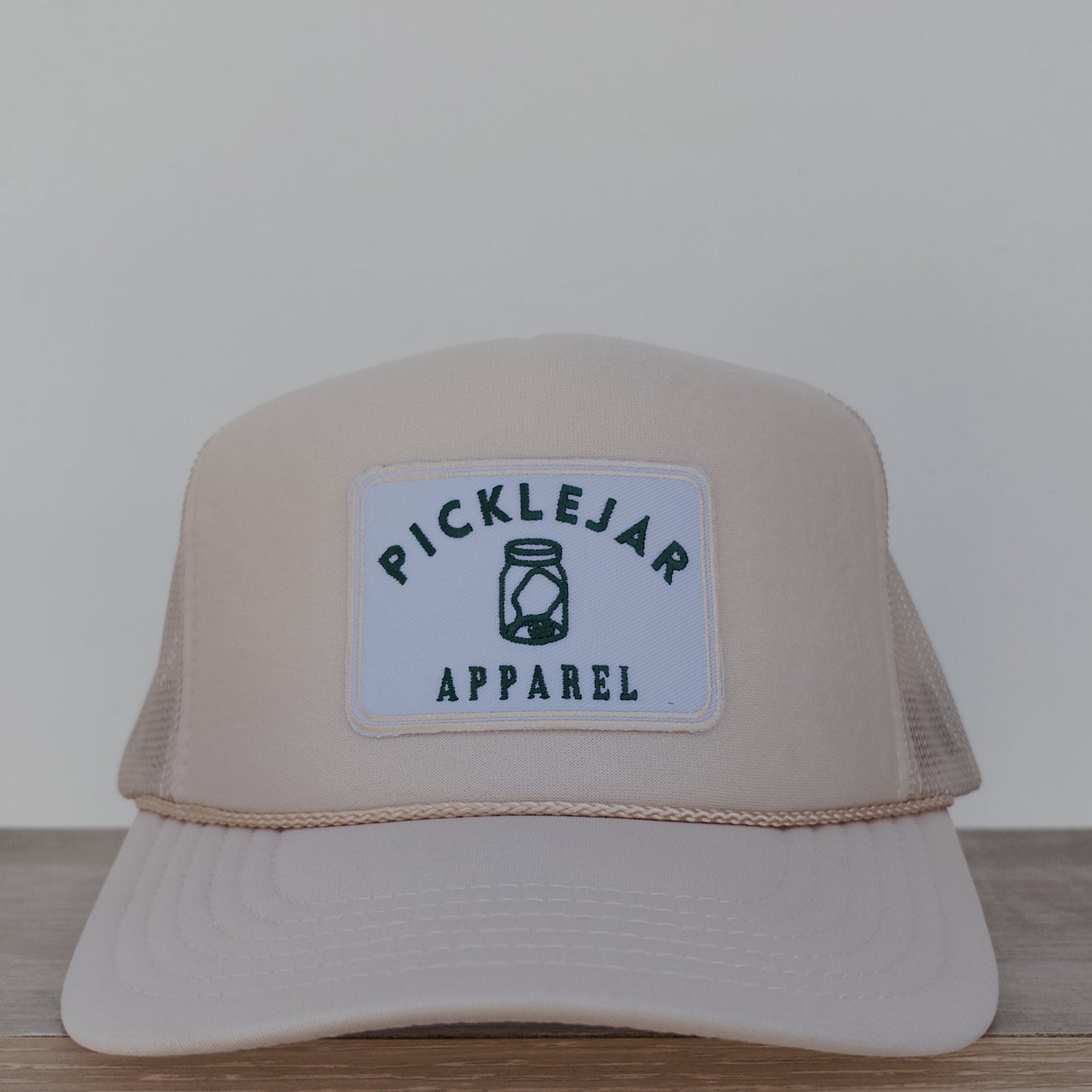 CREAM FOAM TRUCKER HAT WITH EMBROIDERED PATCH