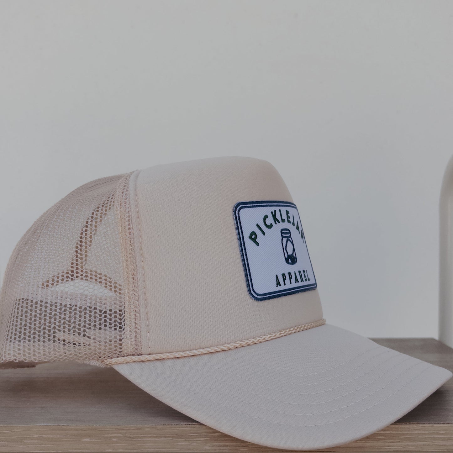 CREAM FOAM TRUCKER HAT WITH EMBROIDERED PATCH
