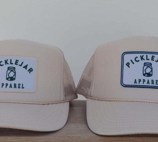 CREAM FOAM TRUCKER HAT WITH EMBROIDERED PATCH
