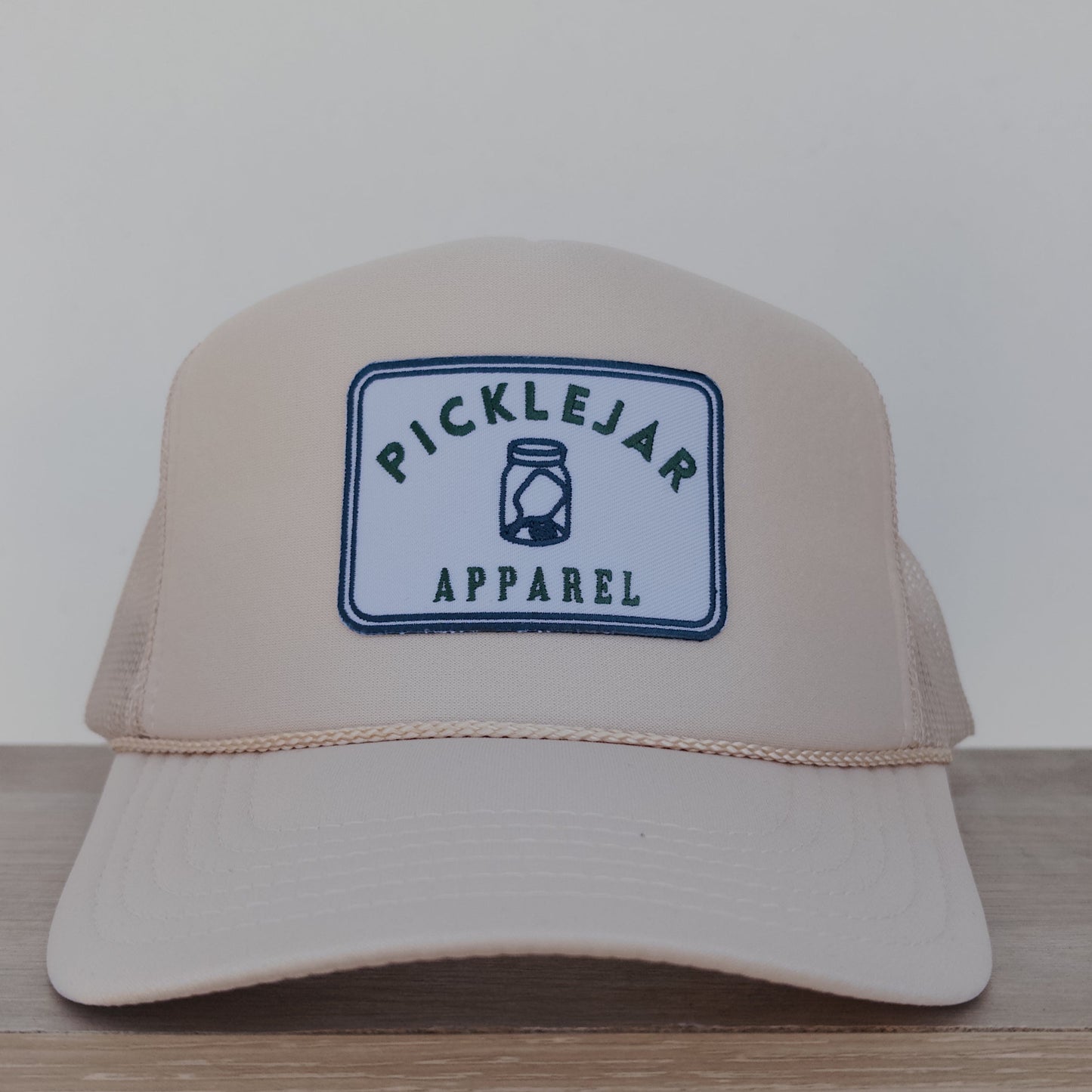 CREAM FOAM TRUCKER HAT WITH EMBROIDERED PATCH